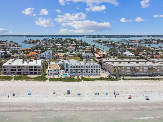 birds eye view of property with a beach view and a water view