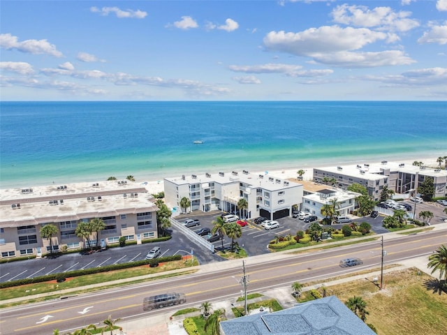 aerial view with a water view and a beach view