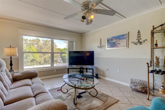 living room featuring a textured ceiling, ornamental molding, ceiling fan, and light tile floors