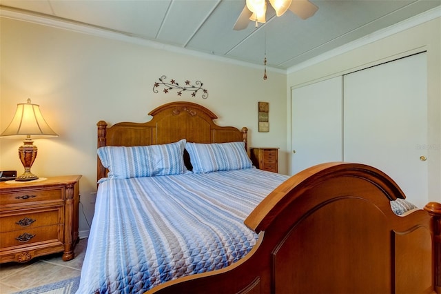 tiled bedroom with a closet, ceiling fan, and crown molding