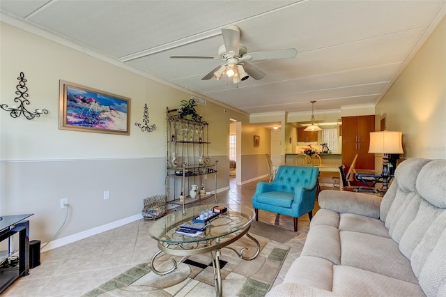 living room featuring ceiling fan, crown molding, and light tile floors