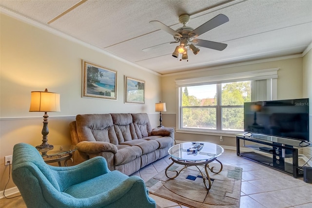 living room featuring a textured ceiling, ornamental molding, ceiling fan, and light tile floors