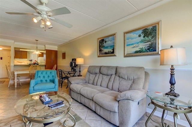 tiled living room featuring ceiling fan and crown molding