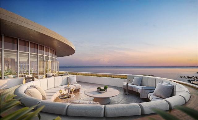 patio terrace at dusk featuring an outdoor living space and a water view