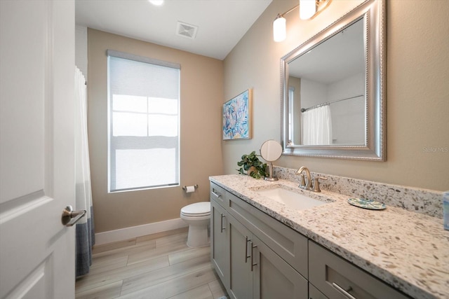 bathroom featuring toilet and vanity