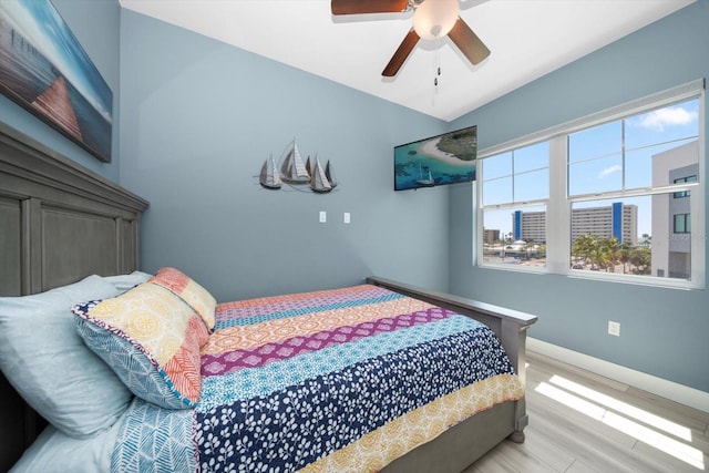 bedroom with ceiling fan and light hardwood / wood-style floors