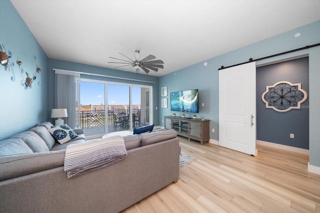 living room featuring light hardwood / wood-style flooring and a barn door