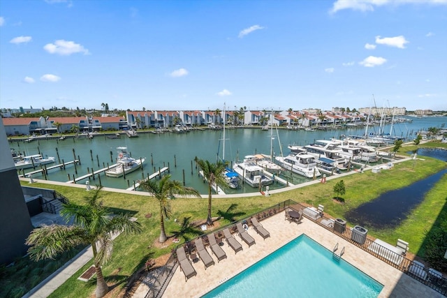 dock area with a water view and a community pool