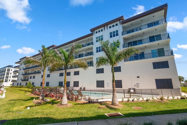 view of building exterior with a community pool