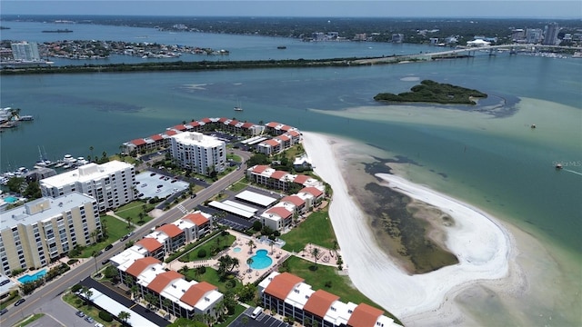 drone / aerial view featuring a water view and a view of the beach