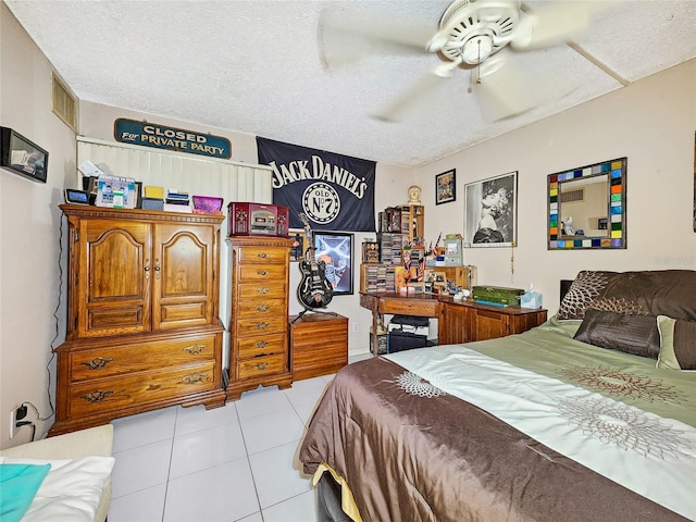 tiled bedroom featuring a textured ceiling and ceiling fan