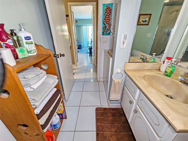 bathroom featuring an enclosed shower, vanity, and tile patterned floors