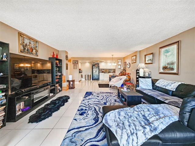 tiled living room featuring a textured ceiling