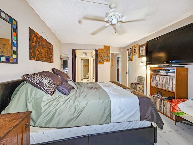 tiled bedroom featuring ceiling fan and a textured ceiling