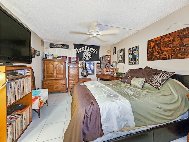 tiled bedroom with a textured ceiling and ceiling fan