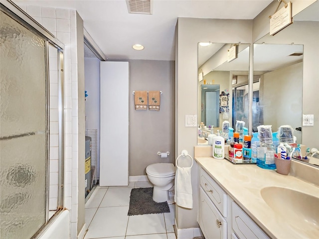 full bathroom with toilet, vanity, tile patterned floors, and enclosed tub / shower combo