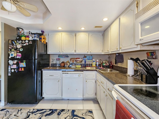 kitchen with white appliances, white cabinets, and light tile patterned flooring