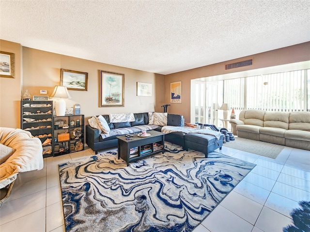 living room with tile patterned floors and a textured ceiling