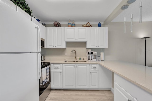 kitchen with white cabinetry, stainless steel appliances, light hardwood / wood-style floors, light stone counters, and sink