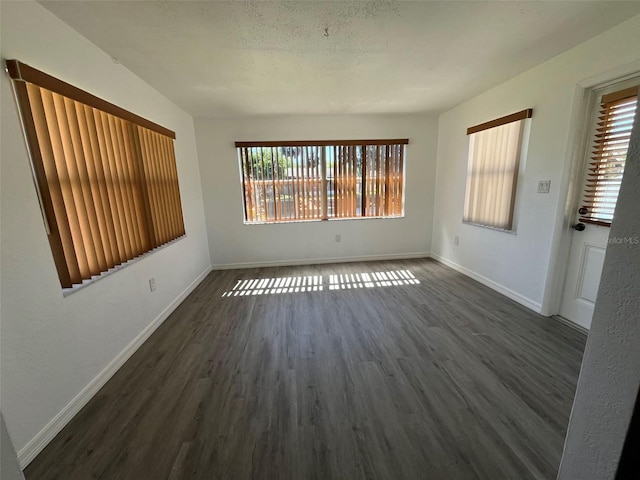 unfurnished room featuring dark wood-type flooring