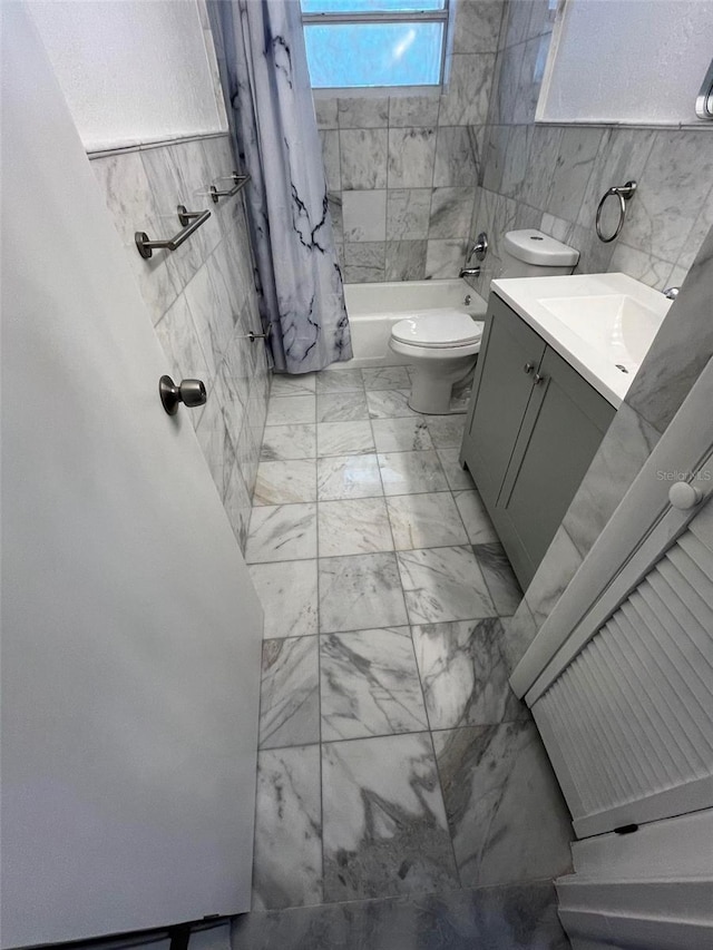 full bathroom featuring tile walls, toilet, tile flooring, shower / bath combo with shower curtain, and vanity