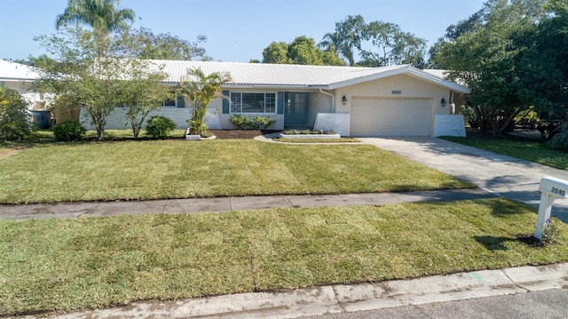 ranch-style house featuring a garage and a front lawn