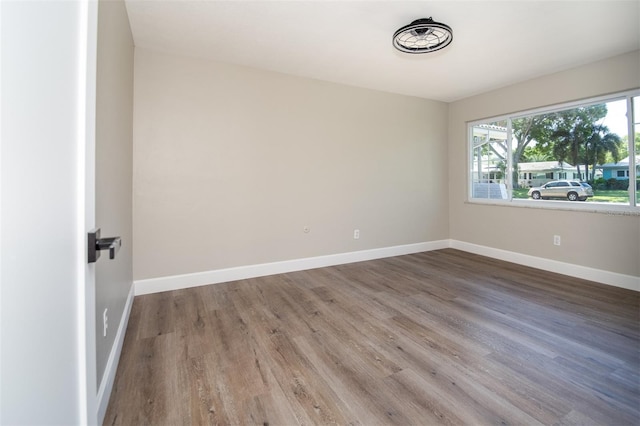 unfurnished room with dark hardwood / wood-style flooring