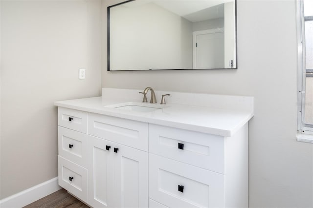 bathroom with hardwood / wood-style floors and vanity