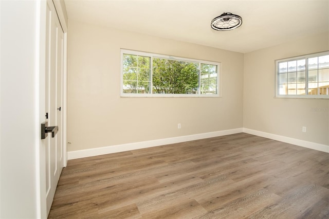 unfurnished room with dark hardwood / wood-style flooring