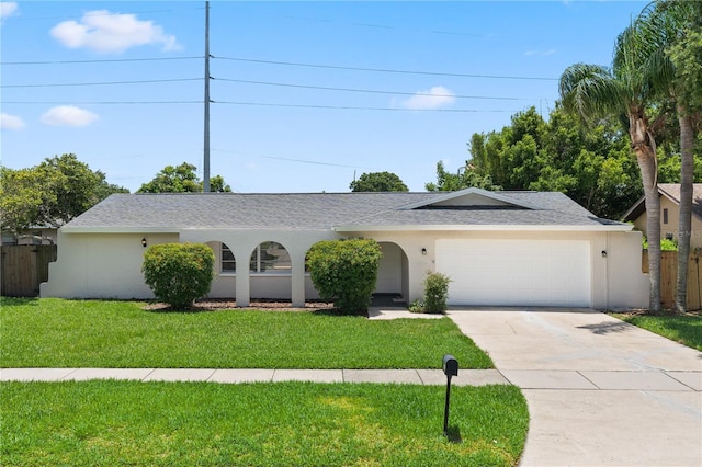 ranch-style house featuring a garage and a front lawn