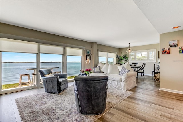 living room with wood-type flooring and a water view