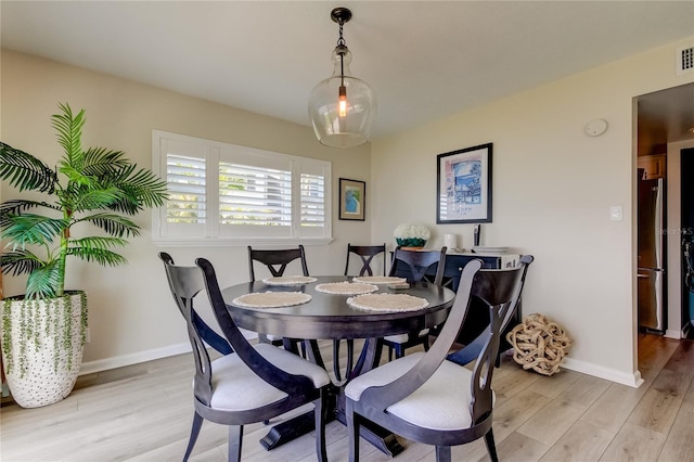 dining area with light hardwood / wood-style floors