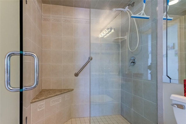 bathroom with walk in shower and toilet