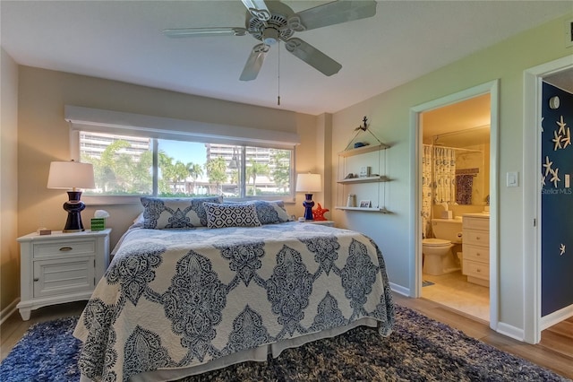 bedroom featuring ceiling fan, hardwood / wood-style flooring, and ensuite bath