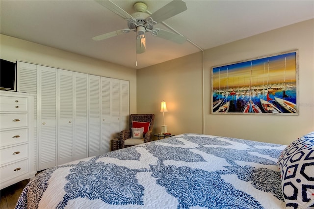 bedroom featuring dark hardwood / wood-style floors, a closet, and ceiling fan