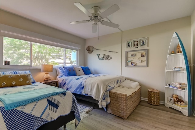 bedroom featuring hardwood / wood-style flooring and ceiling fan