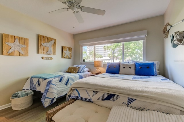 bedroom with hardwood / wood-style floors and ceiling fan