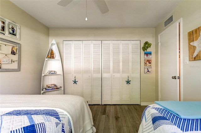 bedroom with hardwood / wood-style floors, a closet, and ceiling fan