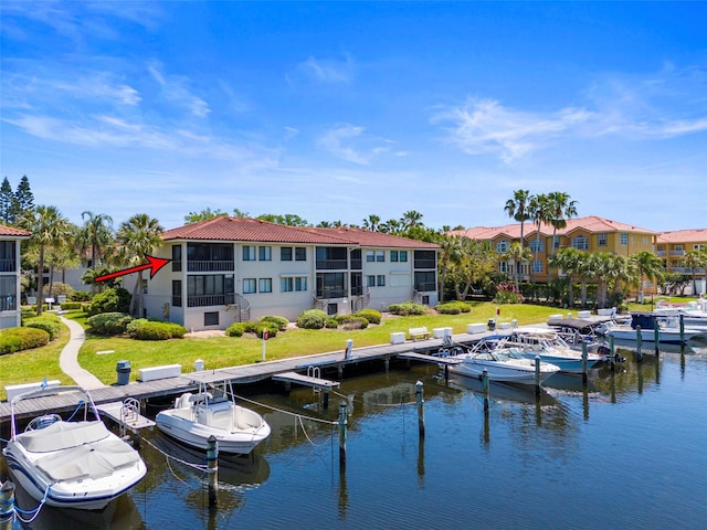 rear view of property with a water view and a yard