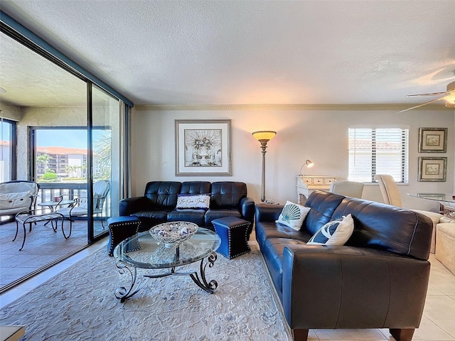 tiled living room featuring ornamental molding, plenty of natural light, ceiling fan, and a textured ceiling