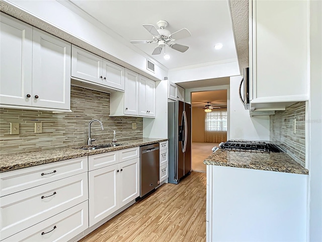 kitchen with backsplash, ceiling fan, and stainless steel appliances