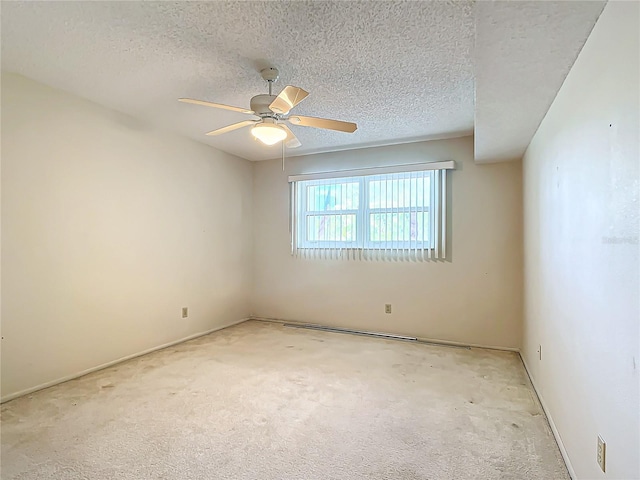 carpeted spare room featuring a textured ceiling and ceiling fan