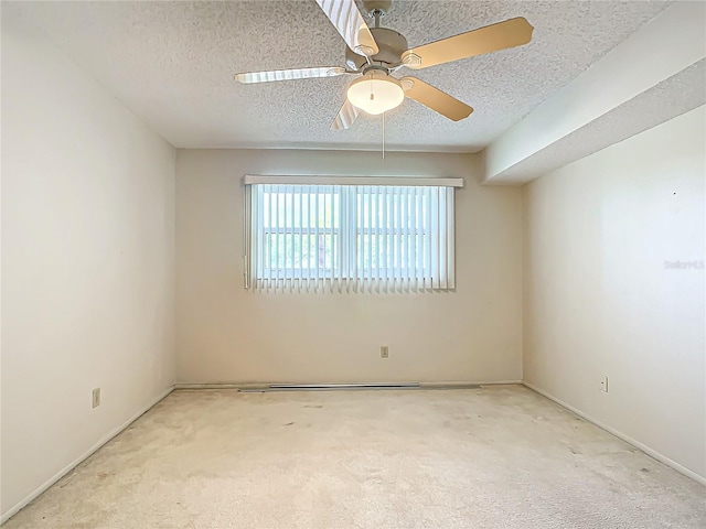 unfurnished room featuring ceiling fan, carpet floors, and a textured ceiling