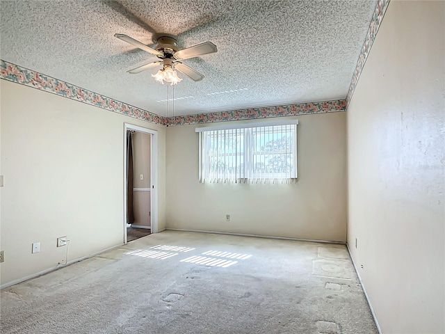 carpeted empty room featuring a textured ceiling and ceiling fan