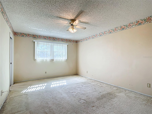 carpeted empty room with a textured ceiling and ceiling fan