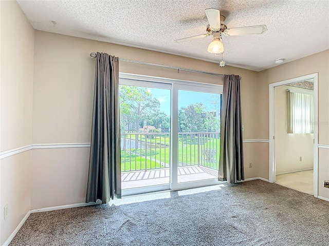 spare room with ceiling fan, carpet flooring, and a textured ceiling