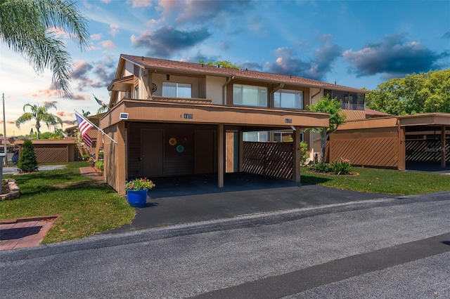 view of front of house with a front lawn and a carport