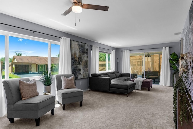 living room featuring light carpet and ceiling fan