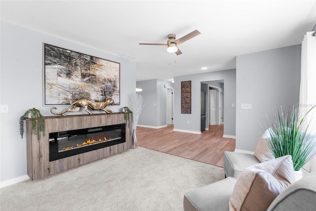 living room featuring light hardwood / wood-style floors and ceiling fan