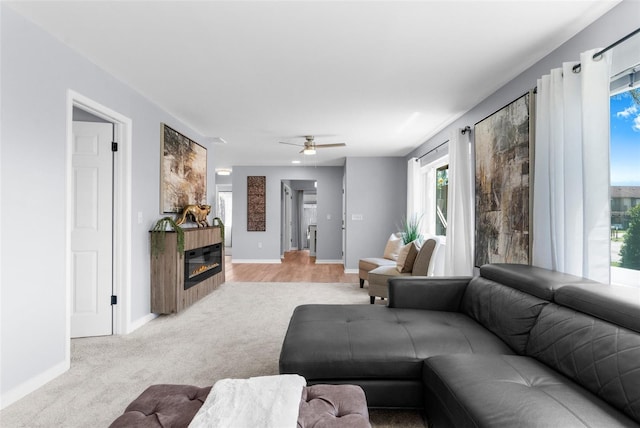 living room featuring ceiling fan and light carpet